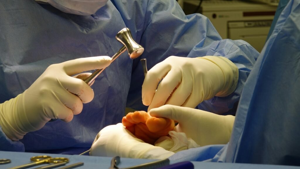 Detailed image of a surgical team performing a foot procedure in a sterile environment.